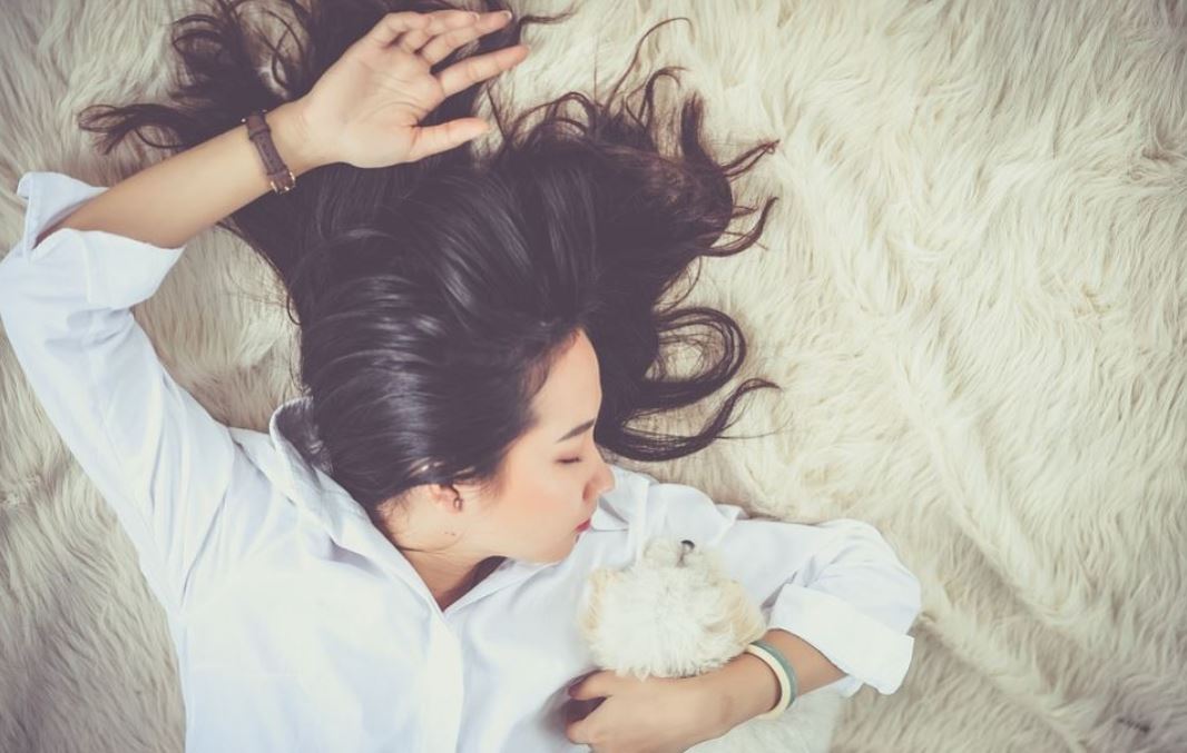 Chica dormida con un perrito.