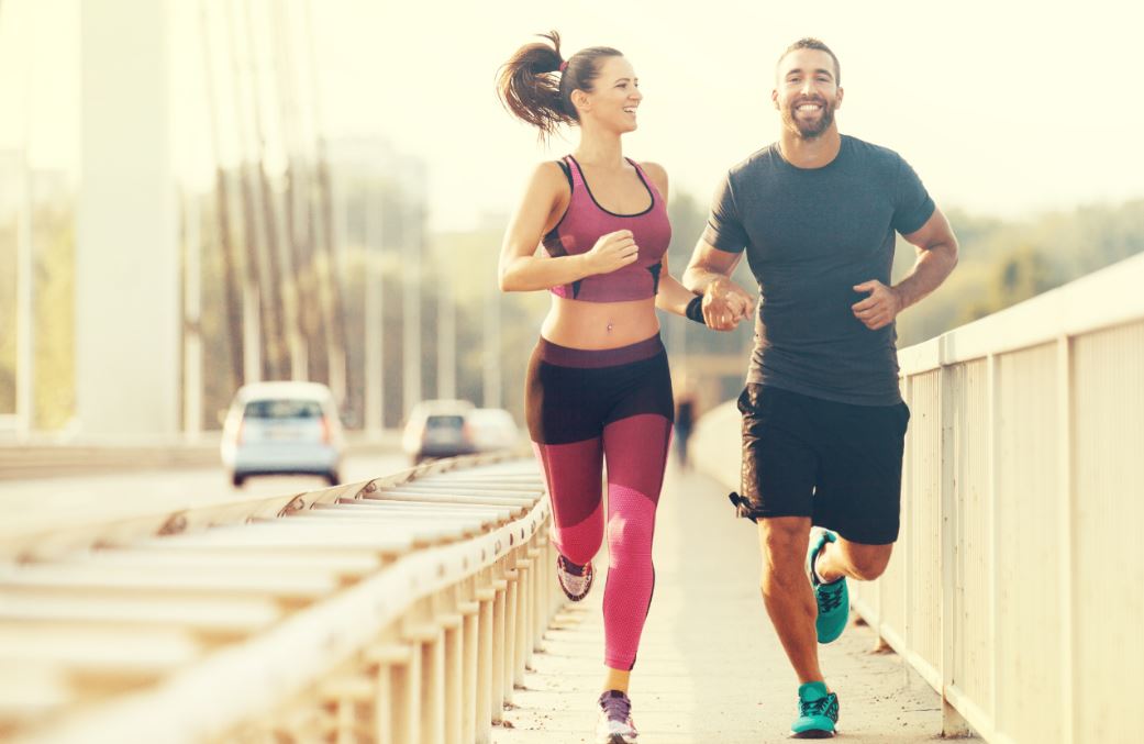 Pareja corriendo por la ciudad.