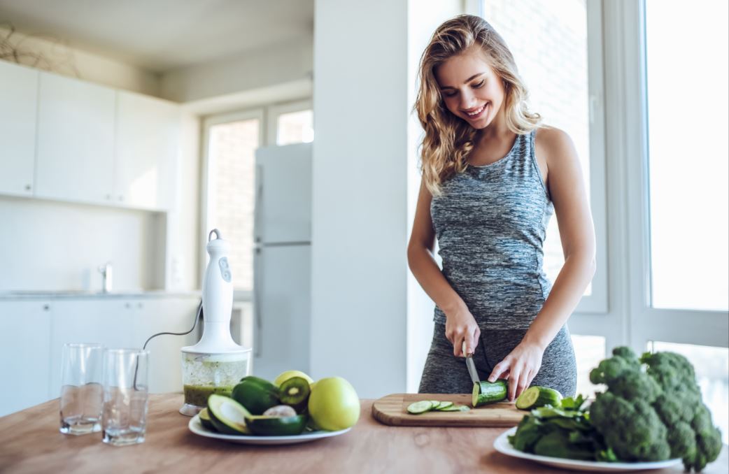 Chica prepara comida antes de hacer deporte.