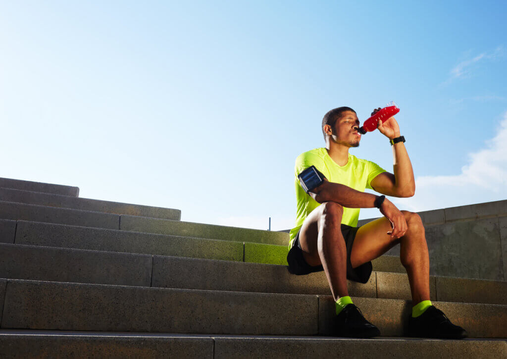 Deportista se hidrata debido a la importancia del sodio en los deportes de resistencia.