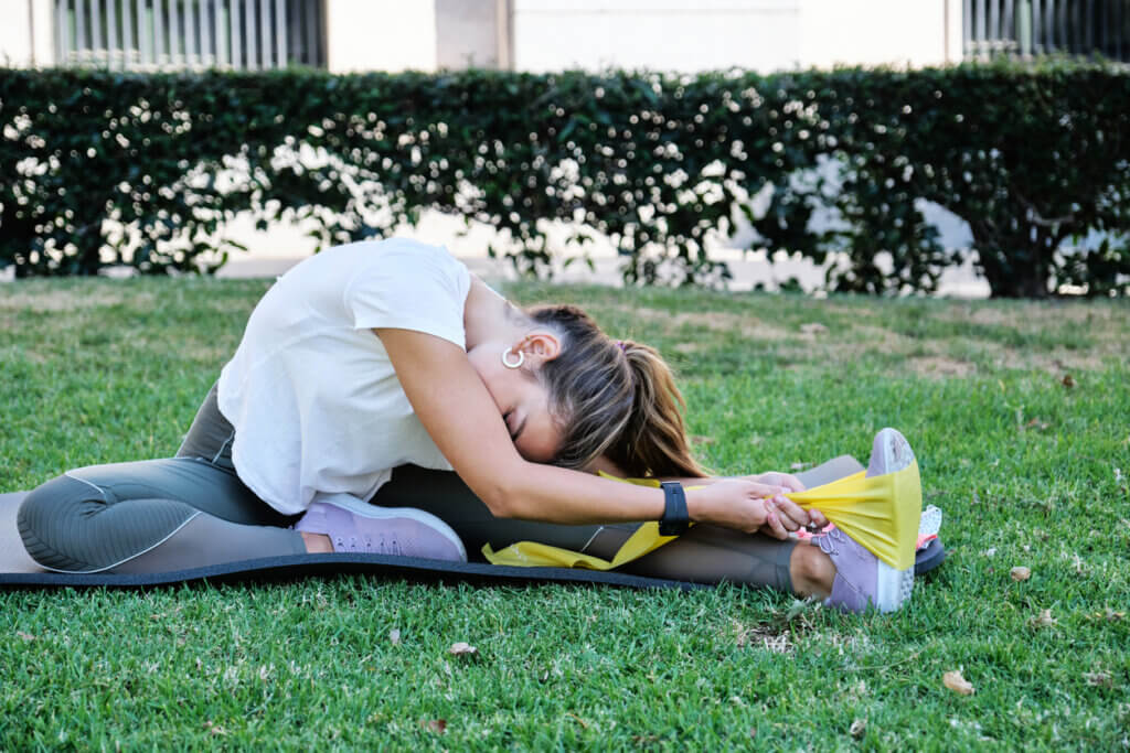 Mujer en rutina de estiramientos aprovechando los beneficios de los alimentos para mejorar su flexibilidad